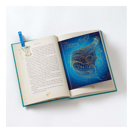 Open book with Peter Pan text and a gold-etched Tinker Bell illustration on a blue pop-up page.