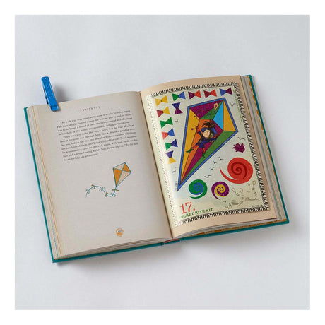 Open Peter Pan book showing a colorful "Pocket Kite Kit" illustration with a boy flying a large kite.