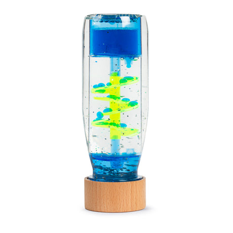 A clear sensory toy with a wooden base, featuring vibrant blue and yellow liquid swirling through a spiral structure, creating a calming effect.