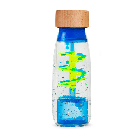 Clear sensory bottle with blue liquid and floating yellow and blue spiral design. Wooden cap. Bright and playful, evokes a calming effect.
