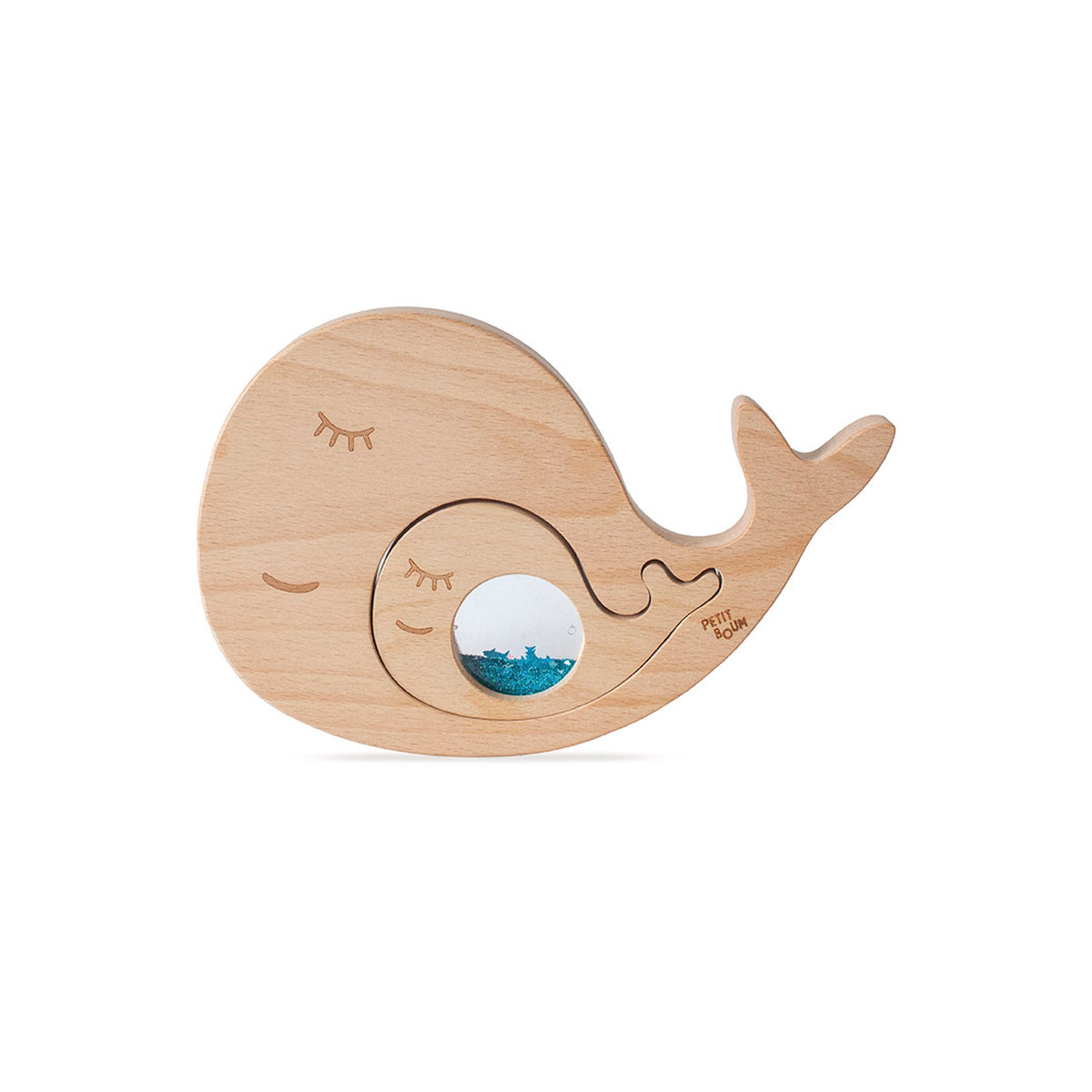 Smaller baby whale piece fitted into the larger wooden whale puzzle piece.