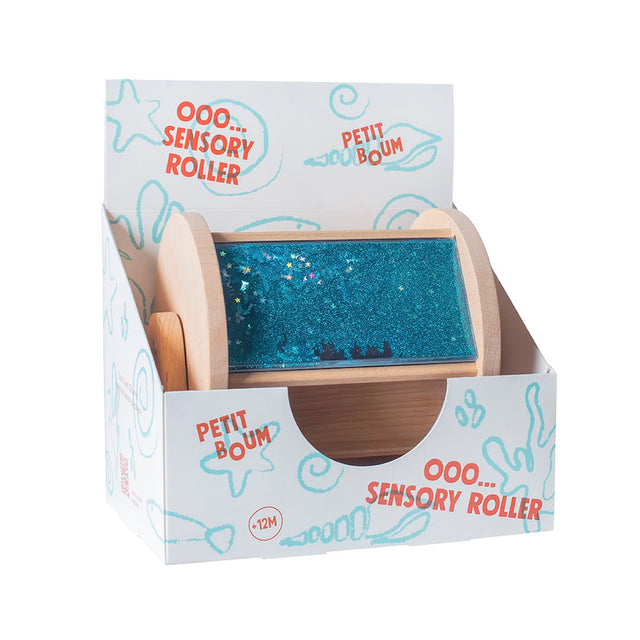 Petit Boum wooden sensory roller in its printed cardboard packaging box.