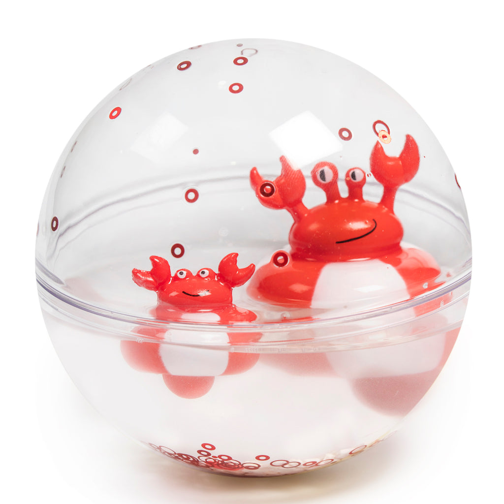 A transparent spherical toy with two cheerful red cartoon crabs inside, surrounded by floating bubbles. The crabs have playful expressions.