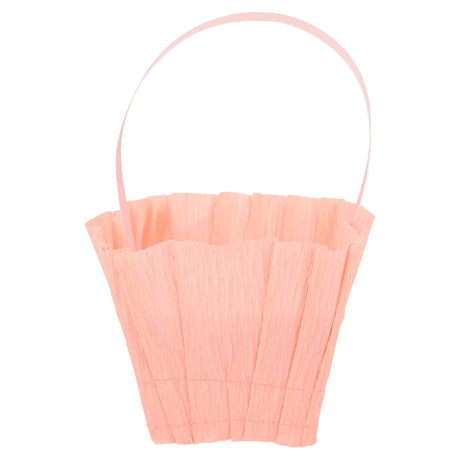 Single pink Meri Meri crepe paper Easter basket with a thin handle on a white background.