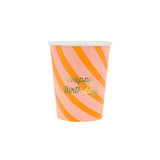 A pink and orange striped paper cup featuring gold "Happy Birthday" text.