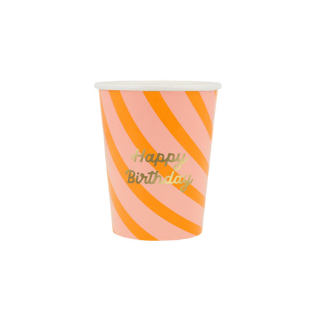 A pink and orange striped paper cup featuring gold "Happy Birthday" text.