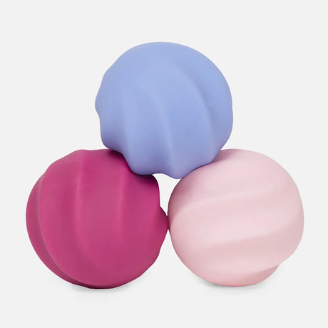 Three soft silicone Speks Odds fidget magnets in swirled blue, magenta, and light pink.