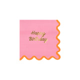 A square pink paper napkin with a wavy orange border and gold "Happy Birthday" text in the center.