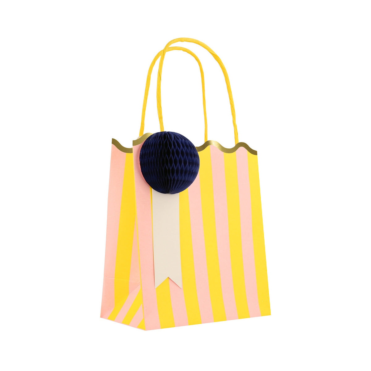 Pink and yellow striped party bag with a scalloped gold edge, yellow handles, and a navy blue honeycomb paper pom-pom.