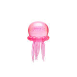 Pink NeeDoh Jelly Squish jellyfish fidget toy with glitter and long tentacles on a white background.