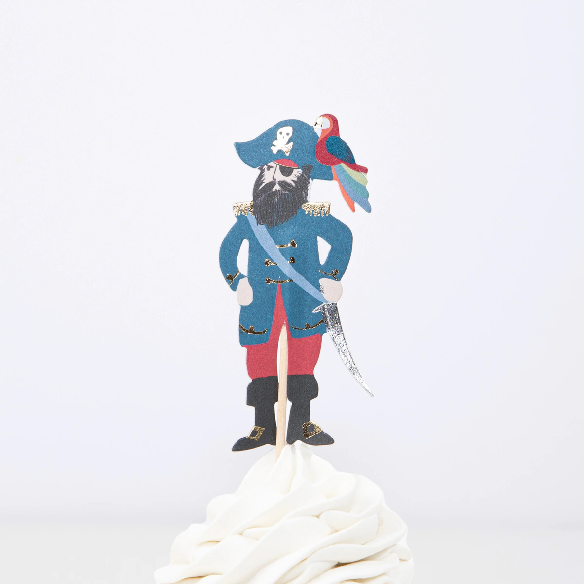Male pirate captain cupcake topper with parrot on hat, sword, and beard on a wooden pick in white frosting.