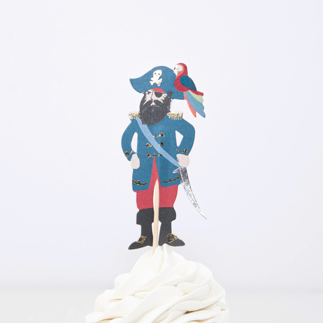 Male pirate captain cupcake topper with parrot on hat, sword, and beard on a wooden pick in white frosting.