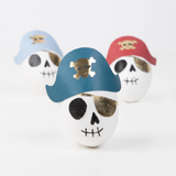 Three pirate skull surprise balls wearing blue, red, and light blue tricorn hats with gold skull motifs.