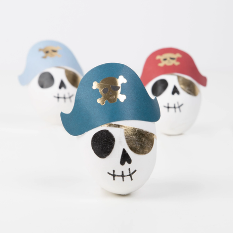 Three pirate skull surprise balls wearing blue, red, and light blue tricorn hats with gold skull motifs.