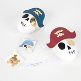 Two pirate skull surprise balls accompanied by pirate stickers and a joke slip.
