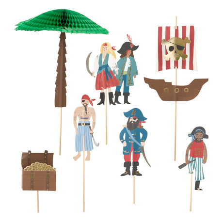 A set of pirate-themed party cake toppers, including a ship, palm tree, treasure chest, and characters.