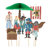 Paper pirate figures on sticks with a treasure chest, palm tree, and a pirate ship backdrop.