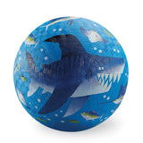 Blue playground ball textured with a large cartoon shark, fish, and bubbles.