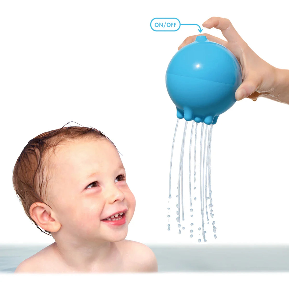 Smiling toddler in bath watching water drizzle from a blue Moluk Plui Rainball toy with on-off finger control.