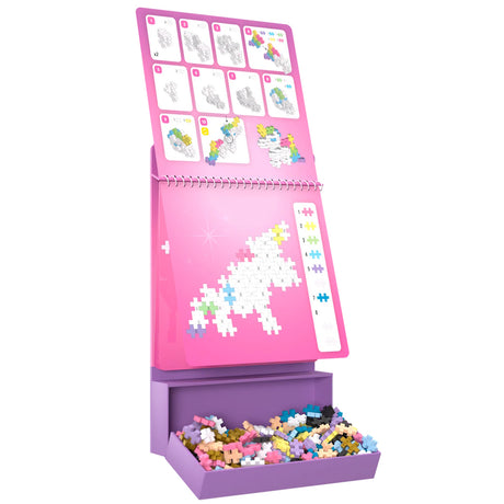 Plus-Plus Fairytale Activity Pad with step-by-step unicorn building instructions and a tray of colorful pieces.