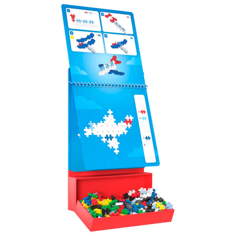 Plus-Plus Activity Pad Transportation set featuring airplane building instructions, colorful pieces, and a red tray.