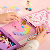 Child using a Plus-Plus activity pad to build a fairytale unicorn. Creative STEM toy for fine motor skill development.