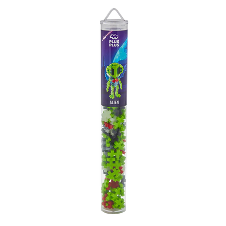 A transparent tube contains Plus-Plus Alien builder pieces in green, red, black, and white. A label depicts an alien with a space-themed background.
