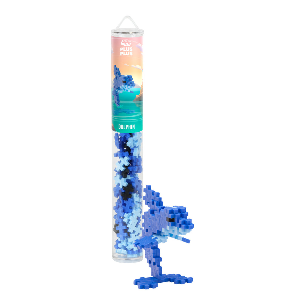 Clear tube containing blue puzzle pieces with the label "Dolphin." Beside it, a dolphin figure is built from the pieces, showing creativity and fun.