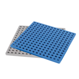 Two square plastic grates, one blue and one white, overlap on a white background. Each grate has a grid pattern of square holes.