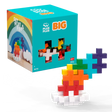 A colorful toy block set on a white background. The box features a rainbow and says "Plus Plus BIG". Blocks form a vibrant, tiered structure.