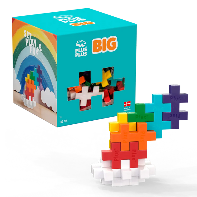 A colorful toy block set on a white background. The box features a rainbow and says "Plus Plus BIG". Blocks form a vibrant, tiered structure.