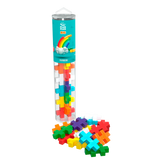 A clear tube labeled “Plus Plus Big Rainbow” holds colorful, cross-shaped pieces. Pieces spill out at the base, forming a vibrant, playful display.