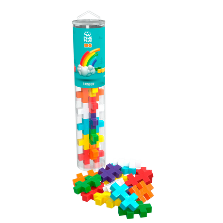 A clear tube labeled “Plus Plus Big Rainbow” holds colorful, cross-shaped pieces. Pieces spill out at the base, forming a vibrant, playful display.