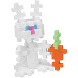 Toy rabbit made of interlocking white blocks holds a multicolored carrot. The rabbit has blue eyes and a pink nose, conveying a playful, creative vibe.