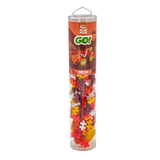 A clear tube labeled "Plus Plus Go! Fire Car" contains colorful interlocking plastic pieces. The packaging shows a model car, suggesting a creative toy.