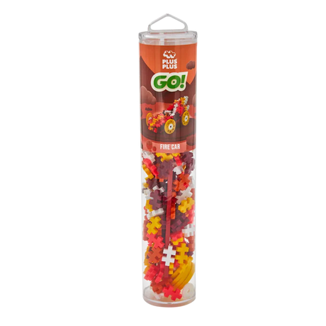 A clear tube labeled "Plus Plus Go! Fire Car" contains colorful interlocking plastic pieces. The packaging shows a model car, suggesting a creative toy.