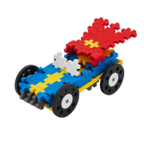 A colorful toy car made from interlocking plastic blocks on a white background. It features a blue body, yellow accents, and red flame elements on top.