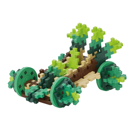 Toy model made of interlocking plus-shaped blocks, resembling a cart or vehicle with two large green wheels and foliage details in various greens.