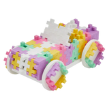 Colorful toy car made from interlocking pastel blocks, featuring shades of pink, yellow, and green, on a white background. Playful and vibrant.
