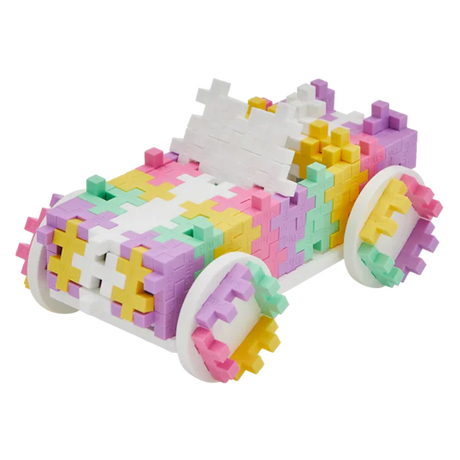 Colorful toy car made from interlocking pastel blocks, featuring shades of pink, yellow, and green, on a white background. Playful and vibrant.