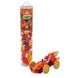 Toy building kit with red, yellow, and white puzzle pieces forming a model car with large yellow wheels. The packaging is a tall, clear tube labeled "Fire Car."