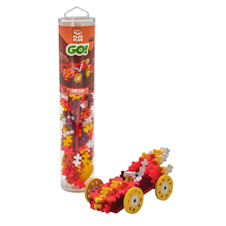 Toy building kit with red, yellow, and white puzzle pieces forming a model car with large yellow wheels. The packaging is a tall, clear tube labeled "Fire Car."