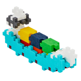 Colorful toy boat made from interconnected cubic pieces. It features blue waves, a multicolored deck, and a black and white structure on a white background.