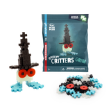 Building toy set named "Creepy Critters Grim" with glow-in-the-dark feature. Includes black, white, and blue pieces, plus red eyes. Fun and playful.