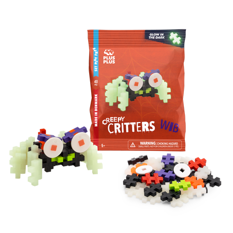 Package of Plus-Plus "Creepy Critters" featuring glow-in-the-dark pieces, shown with a partially assembled creature in colorful plastic blocks.