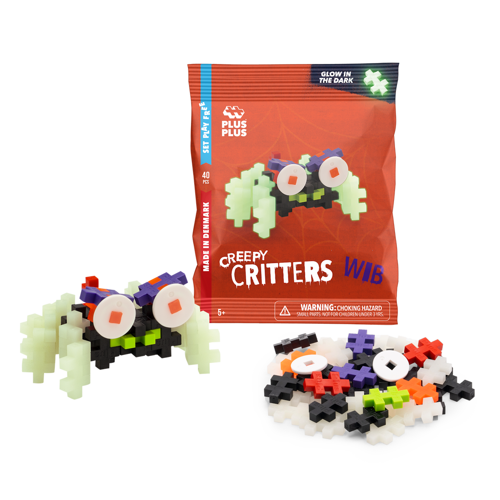 Package of Plus-Plus "Creepy Critters" featuring glow-in-the-dark pieces, shown with a partially assembled creature in colorful plastic blocks.
