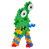 Colorful toy creature made of interlocking blocks with a green body, two large eyes, and multicolored limbs, conveying a playful, whimsical vibe.