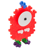 A playful creature made from Plus-Plus building pieces. It has a red pixelated body, large white eye with a black pupil, blue antenna, and green-purple feet.