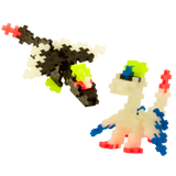 Colorful pixel-style dinosaur toys on a white background. One is black and white with neon accents, the other is white with blue, red, and yellow details. Playful tone.