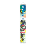 A cylindrical container of Plus-Plus glow-in-the-dark dragon building pieces. The tube is transparent, showcasing multicolored interlocking shapes inside.